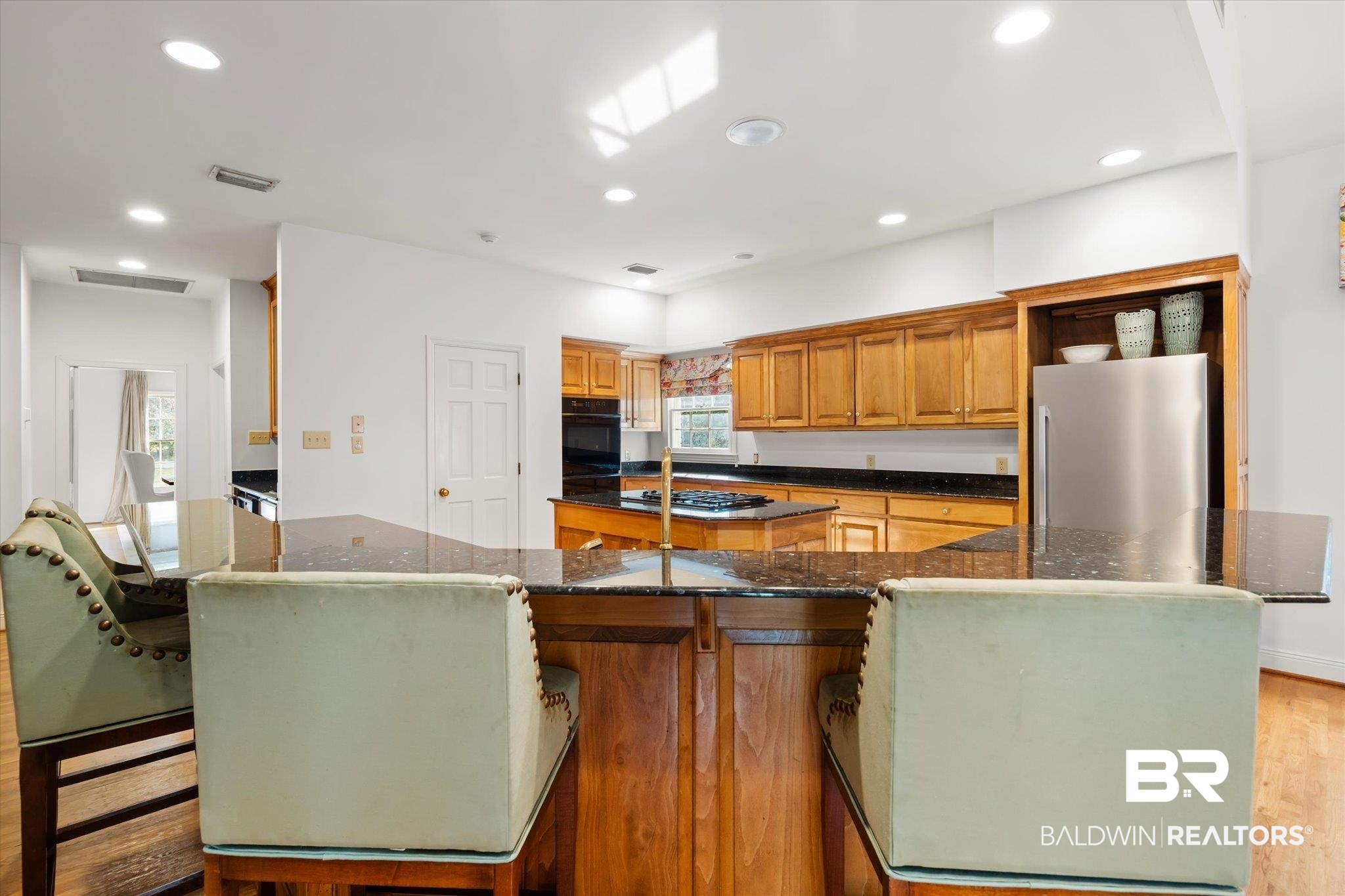 143 Myrtlewood Lane Mobile, AL 36608 - Photo 12 of 55 Kitchen with visible vents, recessed lighting, freestanding refrigerator, a large island, and black oven