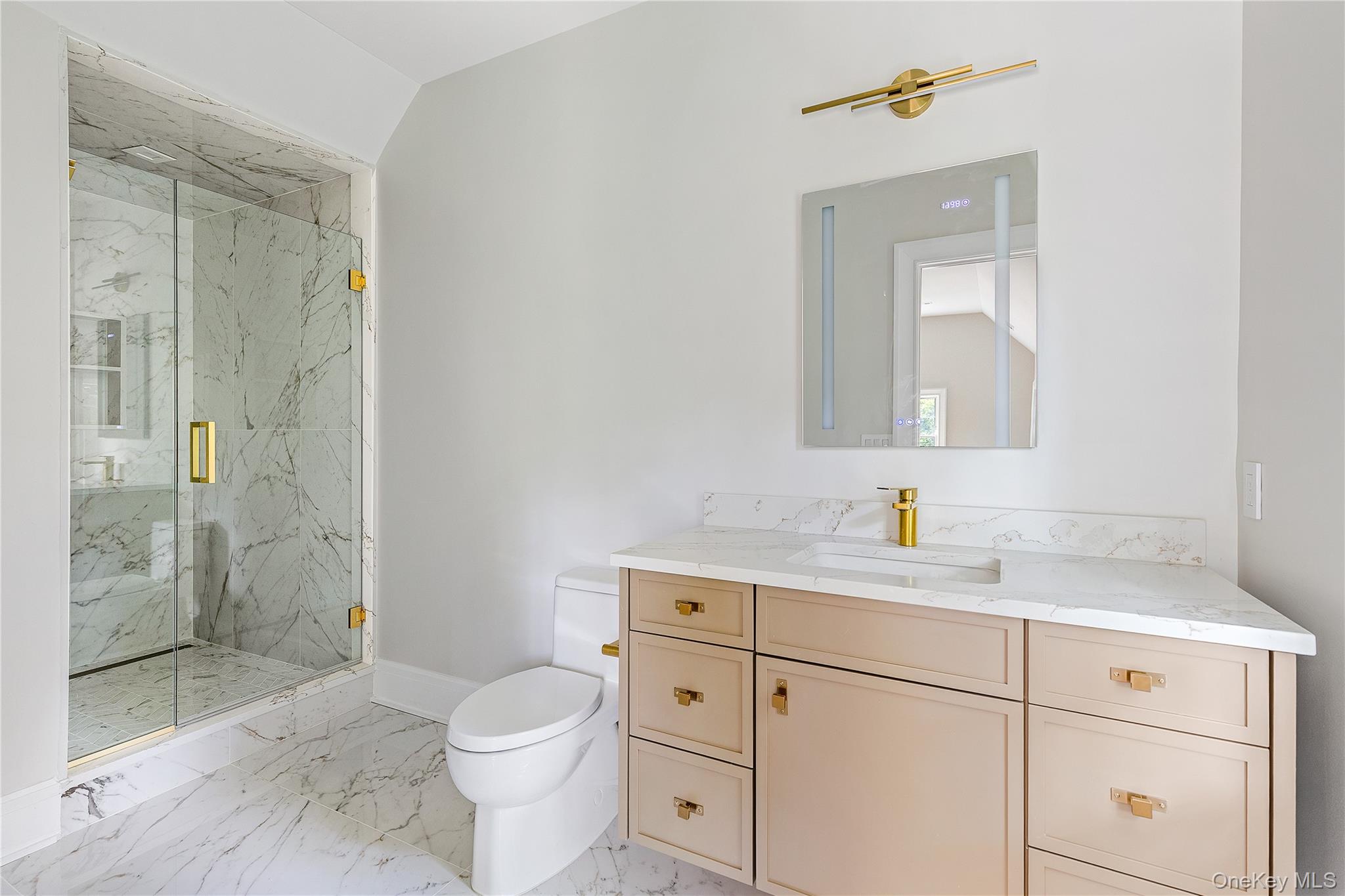 42 Mamaroneck Road Scarsdale, NY 10583 - Photo 35 of 47 A beautifully appointed ensuite bath showcases timeless finishes, custom cabinetry, and a spacious glass-enclosed shower.
