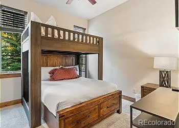 a bedroom with a bed next to a window