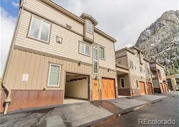 a view of a white house with many windows