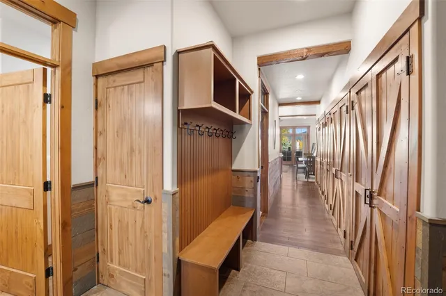 a hallway with dining area and stairs
