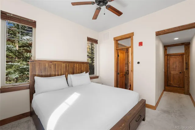 a bedroom with a large bed and a window