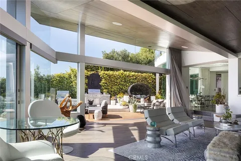 a living room with fireplace furniture and a large window