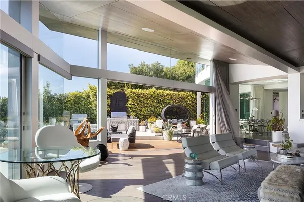 a living room with fireplace furniture and a large window