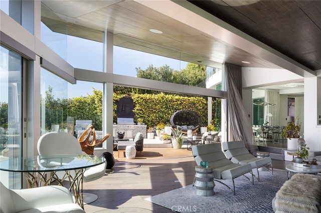 a living room with fireplace furniture and a large window