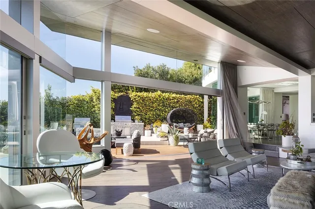 a living room with fireplace furniture and a large window