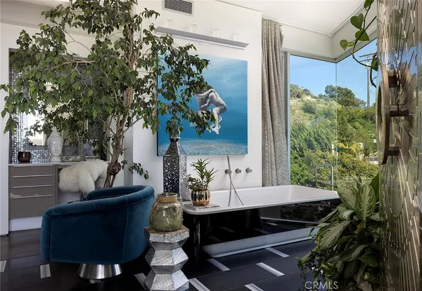 a living room filled with furniture and a potted plant