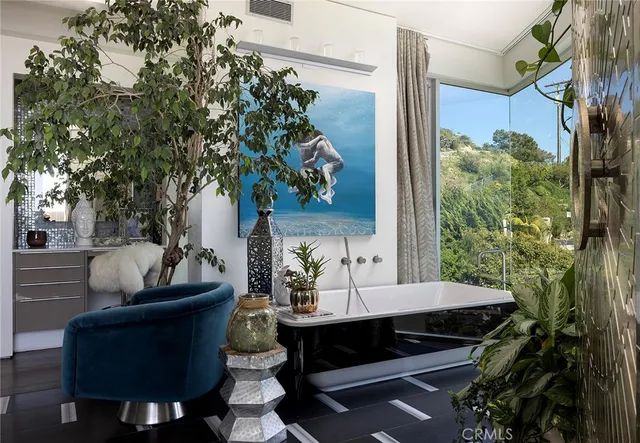 a living room filled with furniture and a potted plant