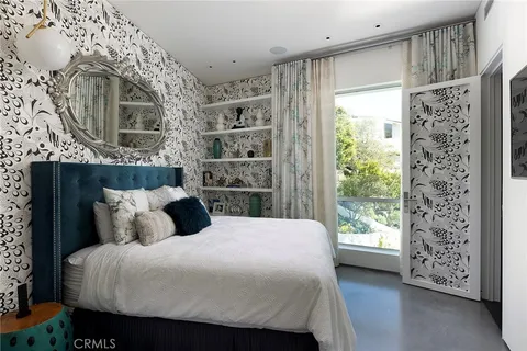 a bedroom with a large bed and a window