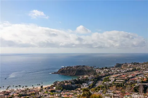 a front view of a house with a yard and balcony