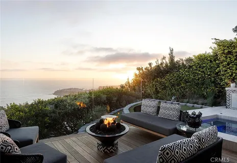 a view of a roof deck with furniture