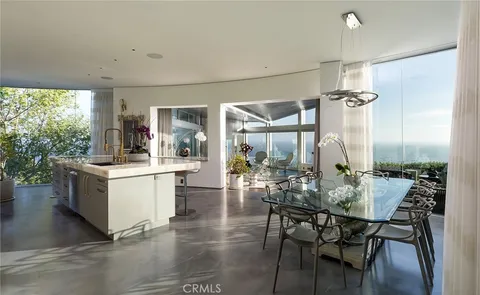 a kitchen with a table chairs and a stove