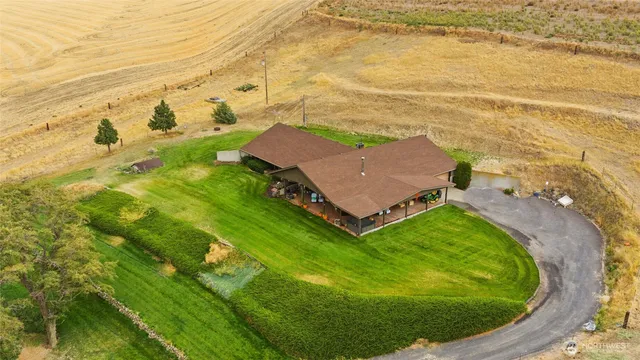 an aerial view of residential houses with outdoor space
