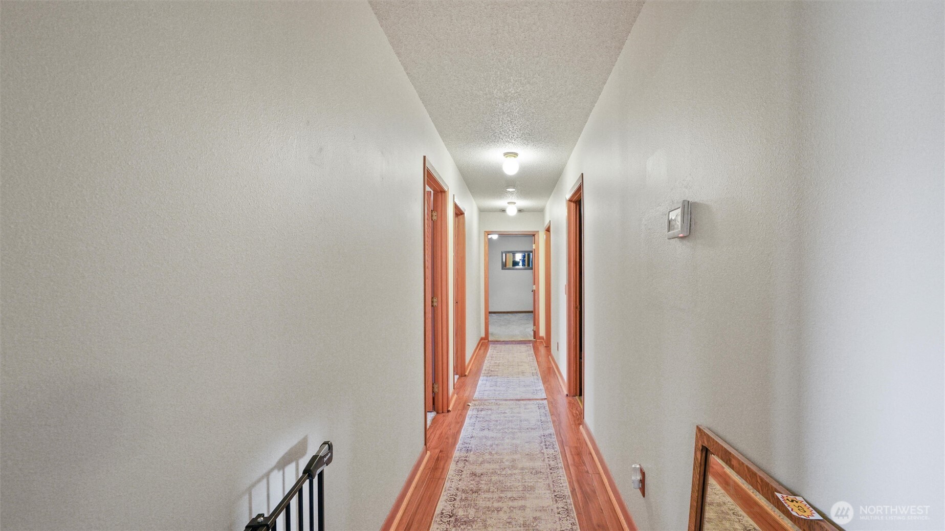 338 East Bramhall Road Dayton, WA 99328 - Photo 12 of 40 a view of a hallway with wooden floor and staircase