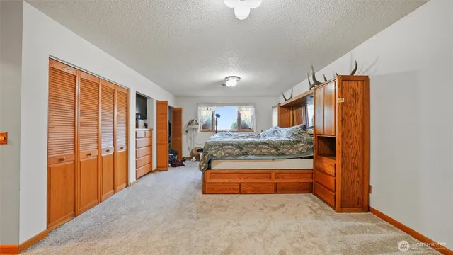 a view of kitchen with stainless steel appliances granite countertop furniture and a window