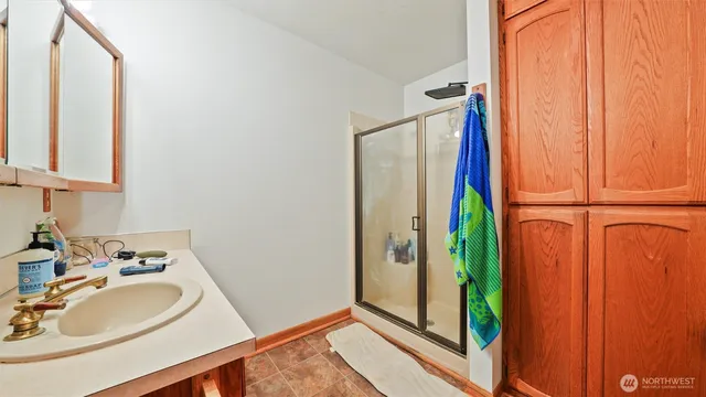 a bathroom with a sink a mirror and shower