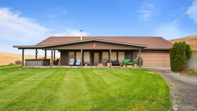 a front view of a house with swimming pool having outdoor seating