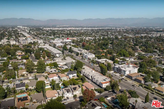 a street sign on a sidewalk next to a road