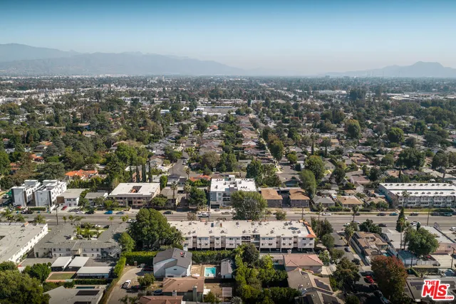 a front view of a building with a garden