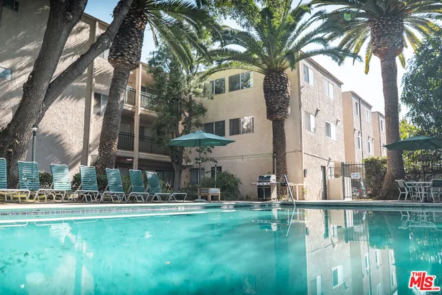 a backyard of a house with lots of green space and fountain view