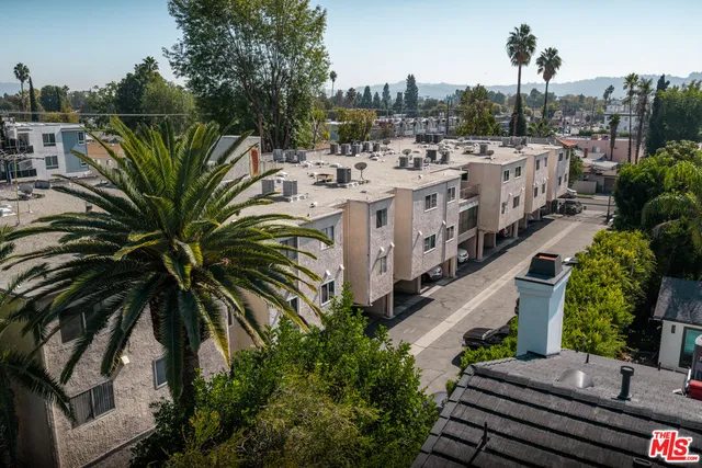 a view of balcony with lawn chairs and wooden fence