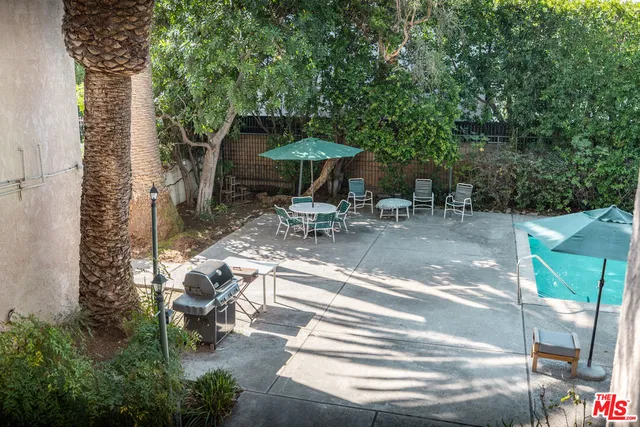 a view of a kitchen with wooden floor and a sink