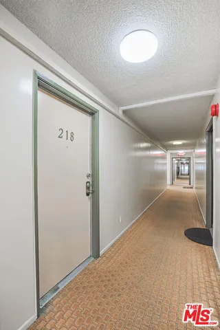 a kitchen with granite countertop a sink a stove and cabinets