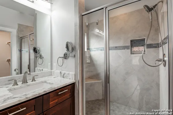 a bathroom with a granite countertop sink mirror and double