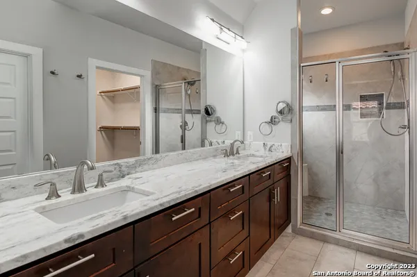 a bathroom with a granite countertop sink a toilet and shower