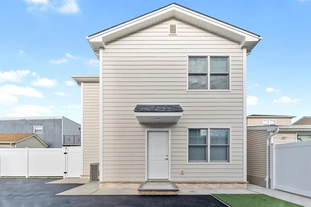 a large kitchen with a large counter top a sink stainless steel appliances and cabinets