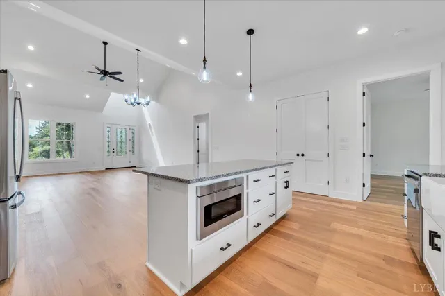 a kitchen with stainless steel appliances a stove a sink and a refrigerator