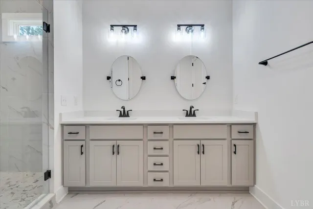 a bathroom with double vanity sinks and a mirror