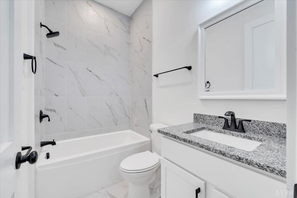 1218 Morgans Church Road Bedford, VA 24523 - Photo 29 of 53 a bathroom with a granite countertop sink a toilet and bathtub