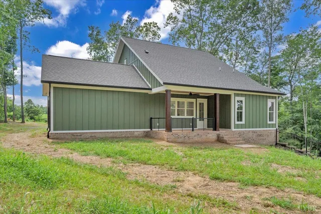 a view of a house with yard and a garden