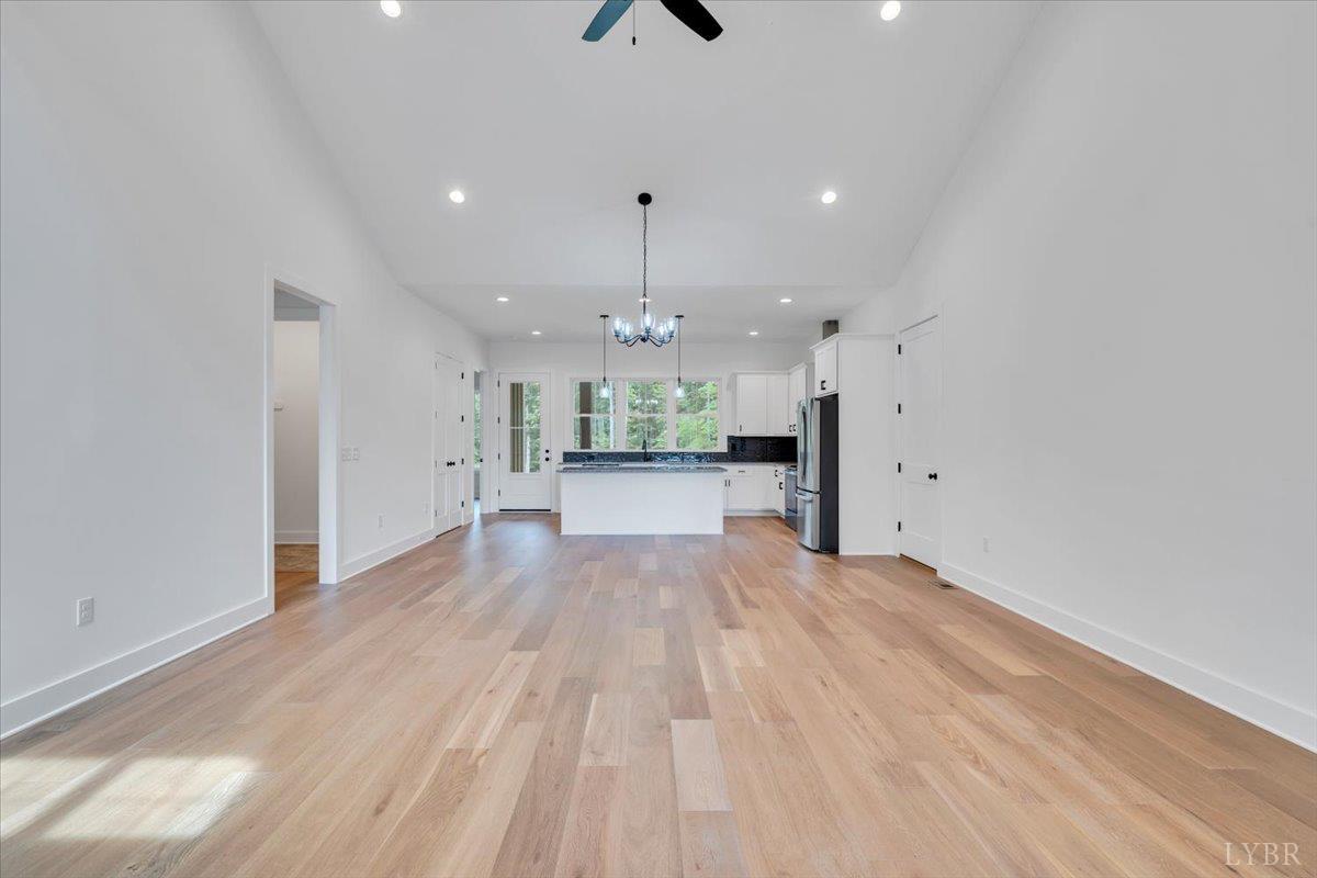 1218 Morgans Church Road Bedford, VA 24523 - Photo 8 of 53 a view of a big room with wooden floor kitchen view and a window