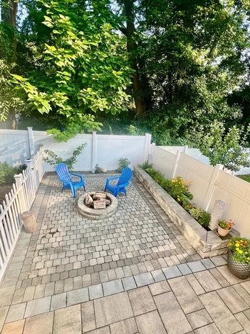 a view of yard from deck with patio