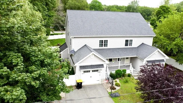 a aerial view of a house next to a yard