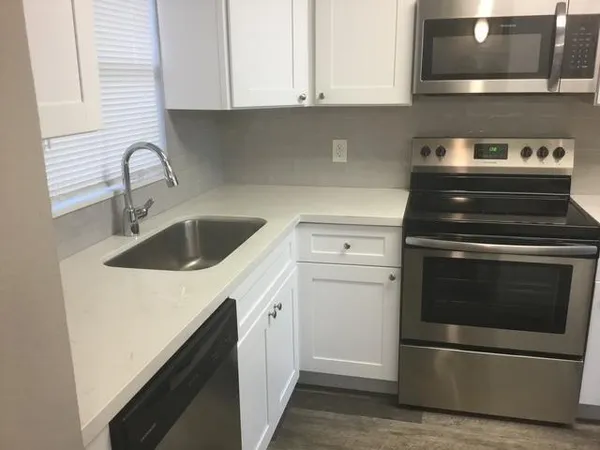 a kitchen with a sink and cabinets