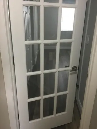a view with granite countertop white cabinets and a sink