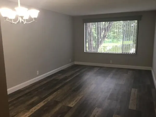 a view of room with window and hardwood floor