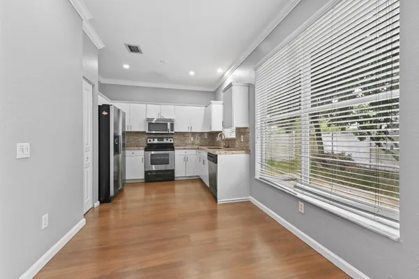 a kitchen with granite countertop a refrigerator and a sink