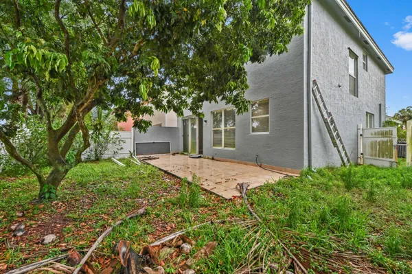 a brick house with trees in front of it