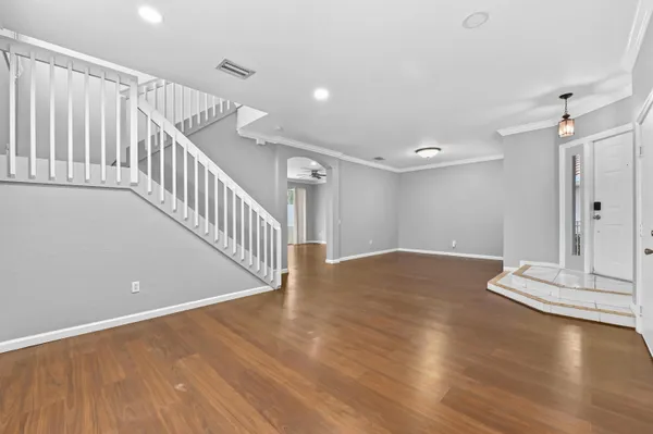 a view of a room with wooden floor