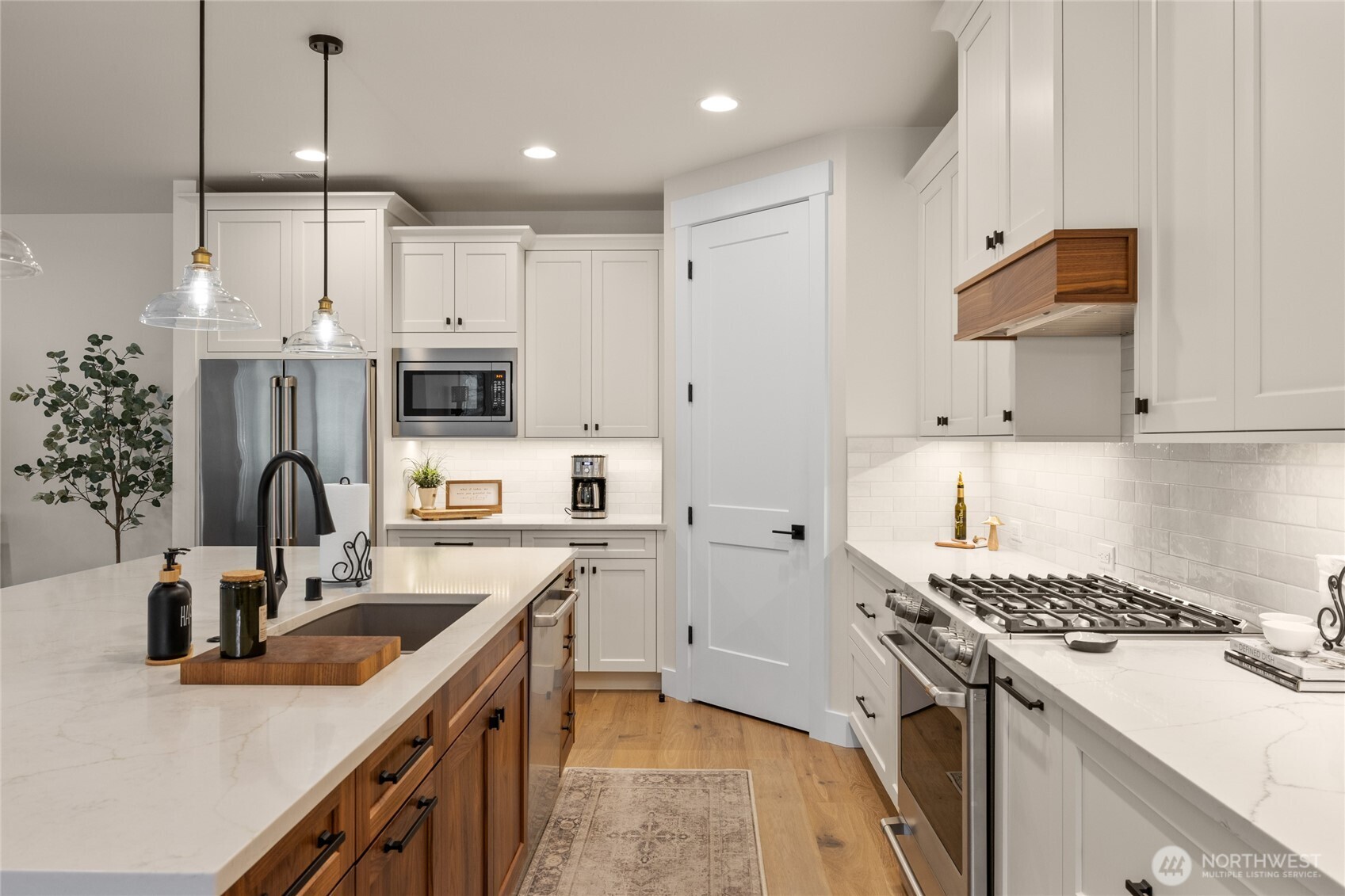 1111 Old Cedars Road Cle Elum, WA 98922 - Photo 7 of 31 a kitchen with kitchen island white cabinets a sink a stove and a refrigerator