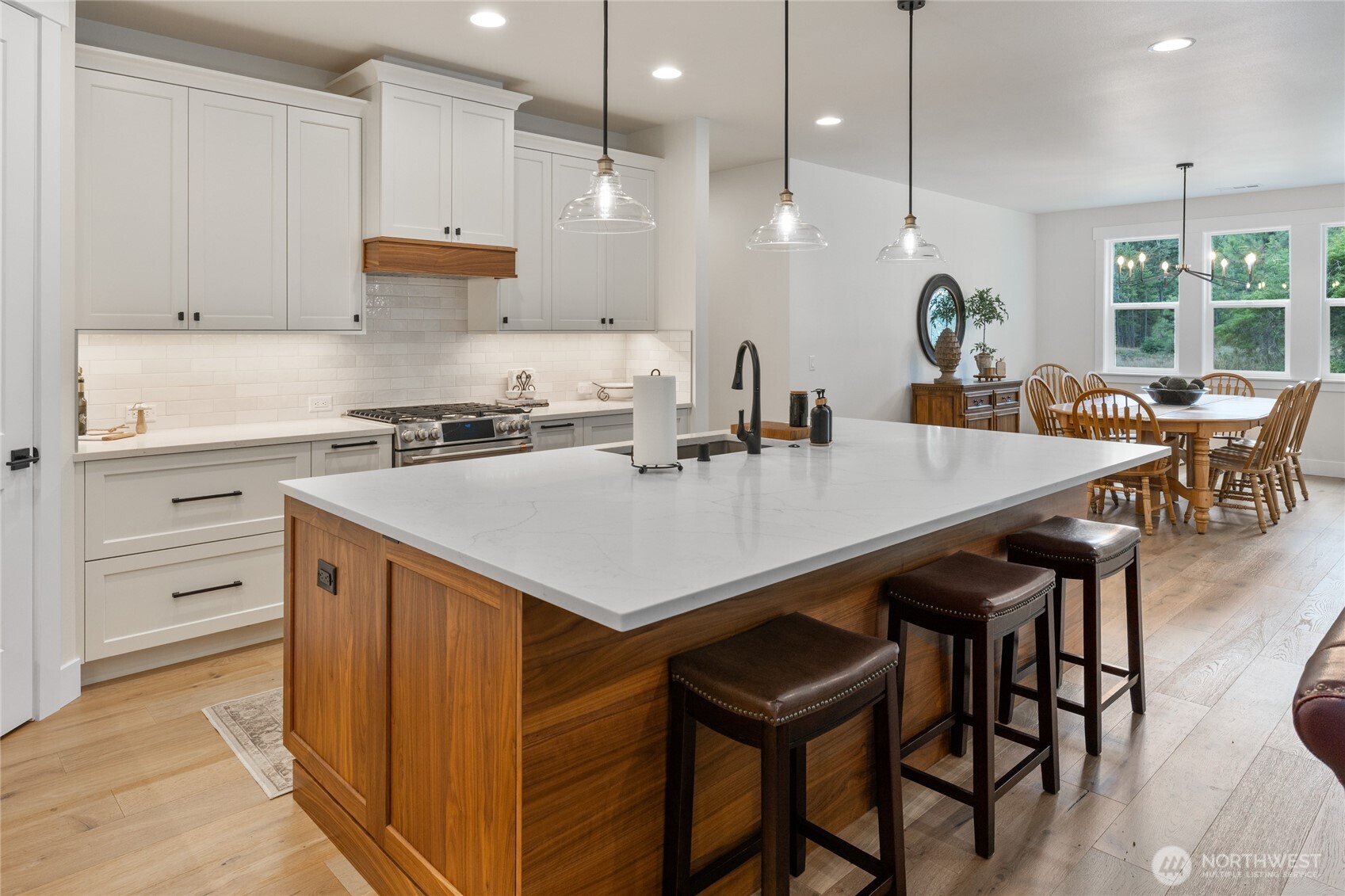 1111 Old Cedars Road Cle Elum, WA 98922 - Photo 9 of 31 a kitchen with a stove a refrigerator a sink a dining table and chairs