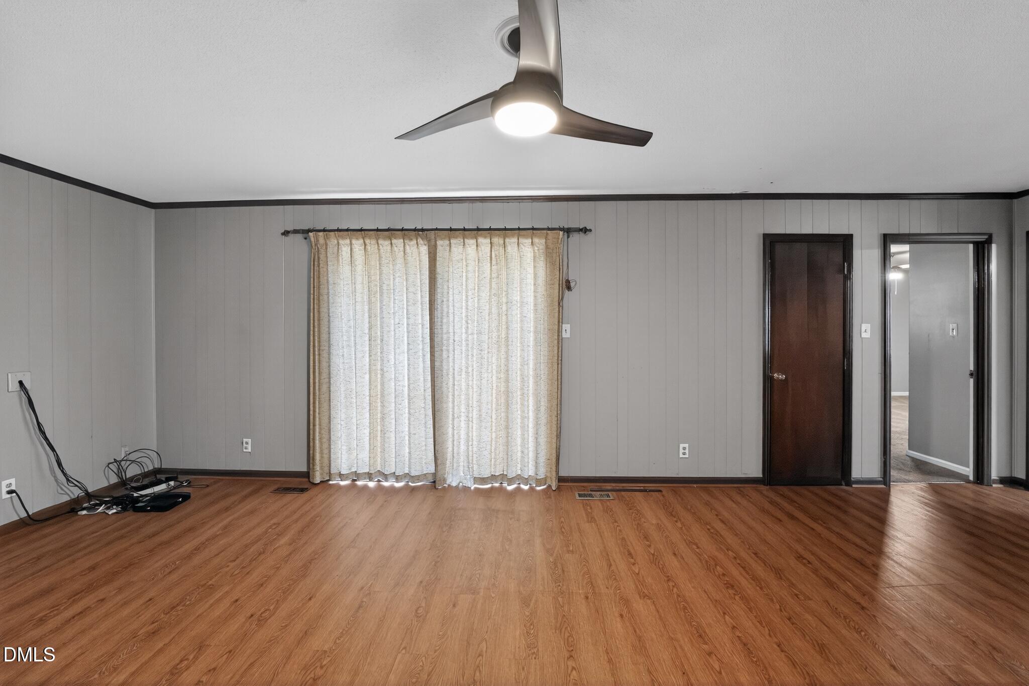 1034 Jerome Road Durham, NC 27713 - Photo 13 of 35 an empty room with wooden floor and windows