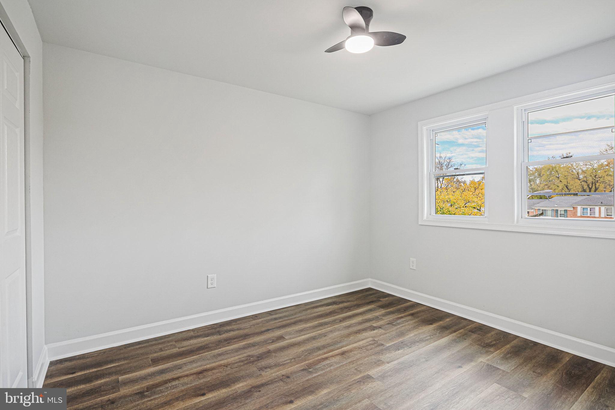 4702 Vancouver Road Baltimore, MD 21229 - Photo 14 of 33 a view of an empty room with wooden floor and a window