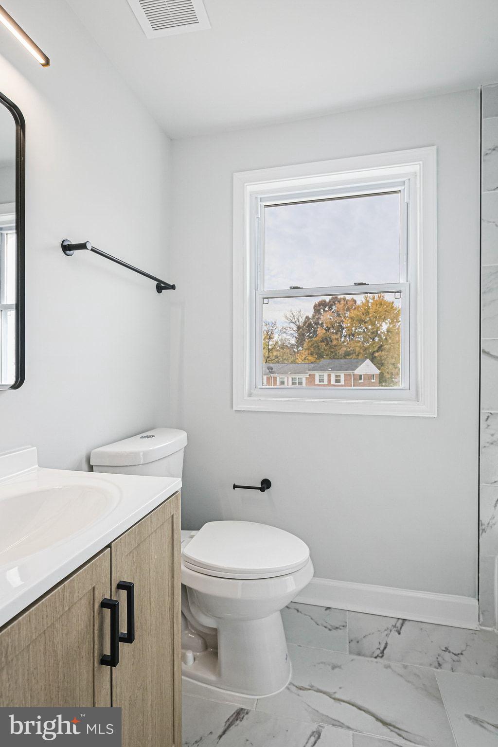 4702 Vancouver Road Baltimore, MD 21229 - Photo 16 of 33 a bathroom with a toilet a sink and mirror