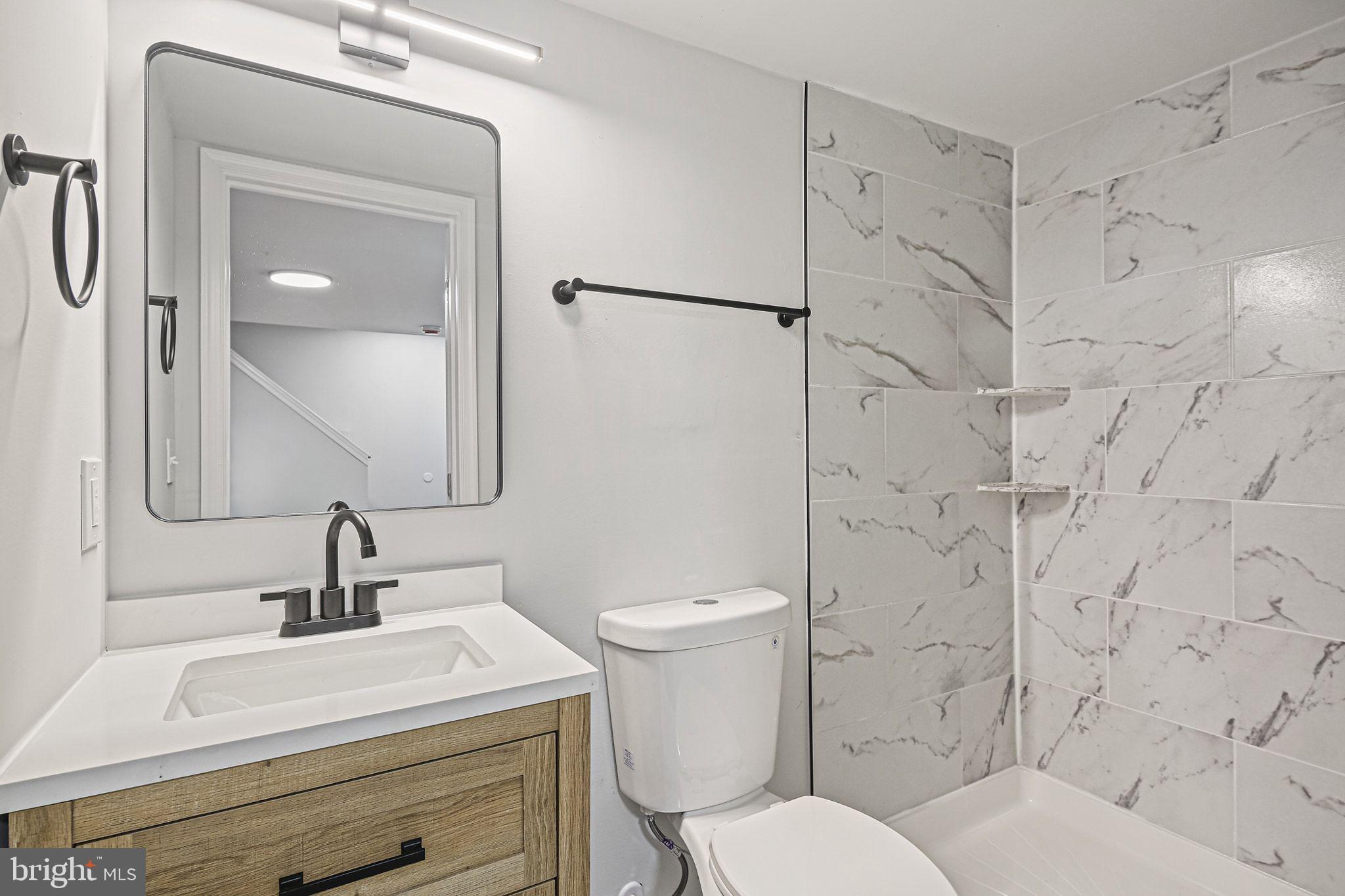 4702 Vancouver Road Baltimore, MD 21229 - Photo 27 of 33 a white toilet sitting next to a bathroom sink