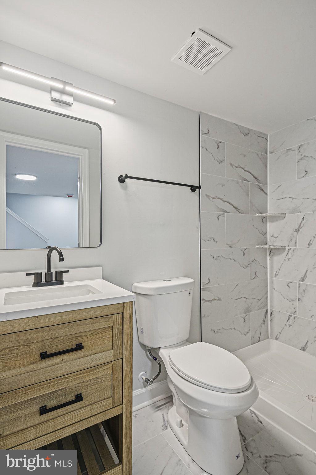 4702 Vancouver Road Baltimore, MD 21229 - Photo 28 of 33 a bathroom with a sink a toilet a mirror and shower